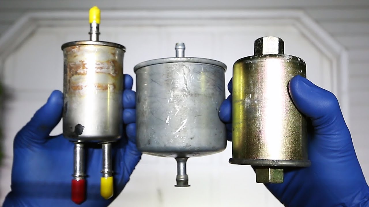 Two Hands holding three different types of Clark forklift fuel filters